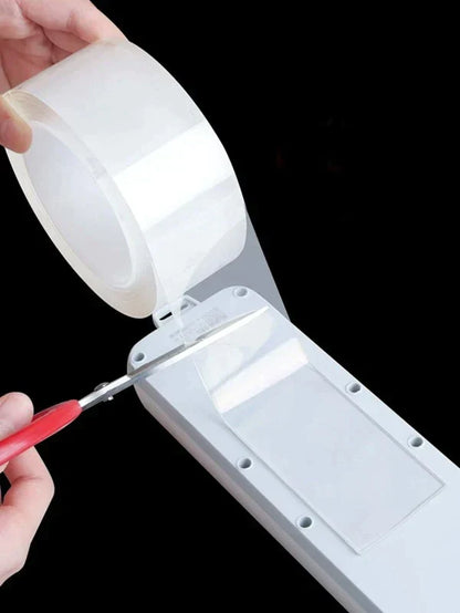 Double sided tape holding an object to a wall
