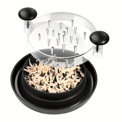 Black chicken shredder with clear lid showing shredded chicken inside