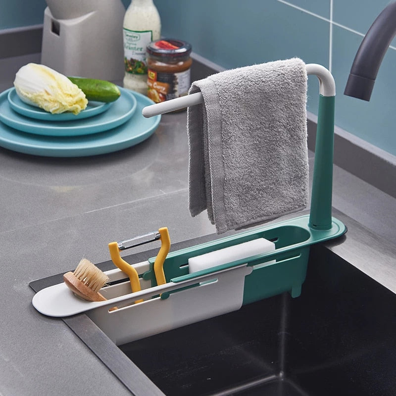 Telescopic sink rack holding a sponge and brush over a sink