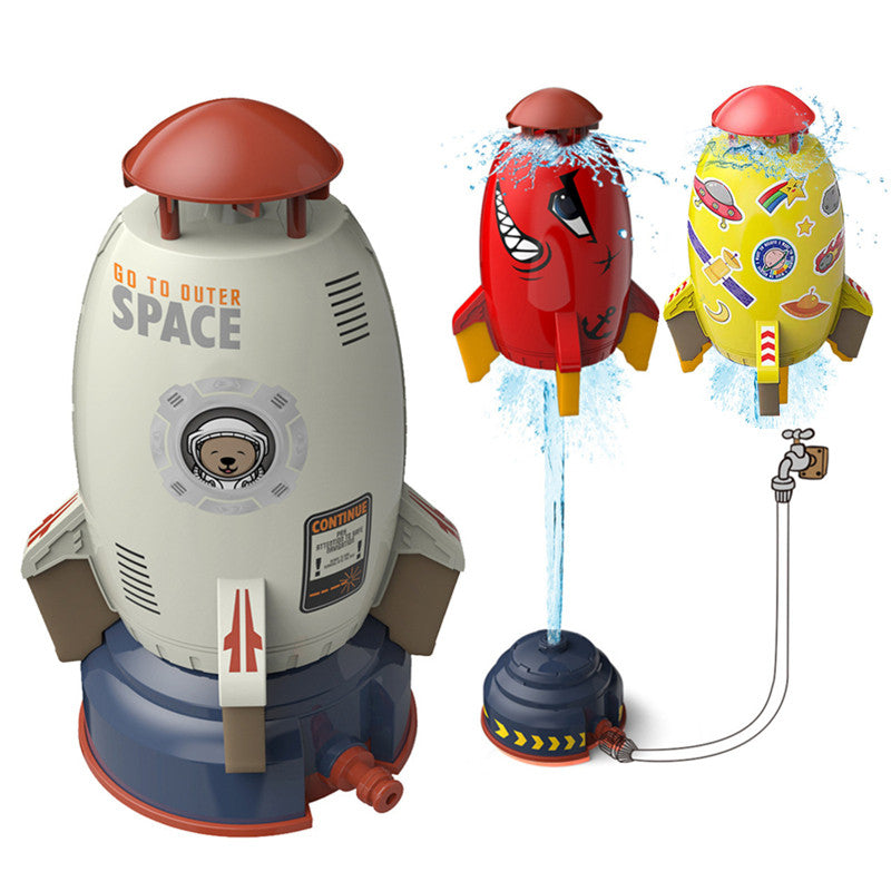 Children playing with the rocket sprinkler on a lawn